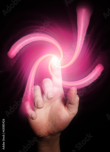 Hand pointing behind shiny swirl