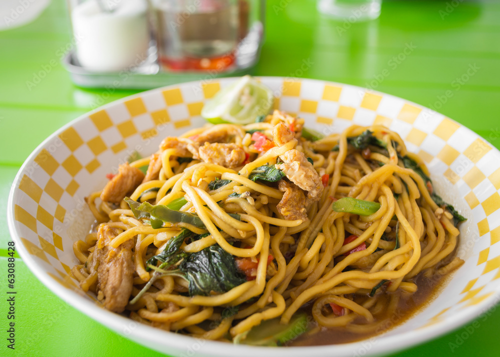 stir fried yellow noodles with basil leaf, chili and pork