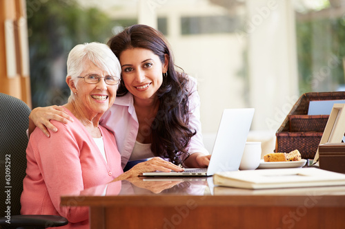 Adult Daughter Helping Mother With Laptop