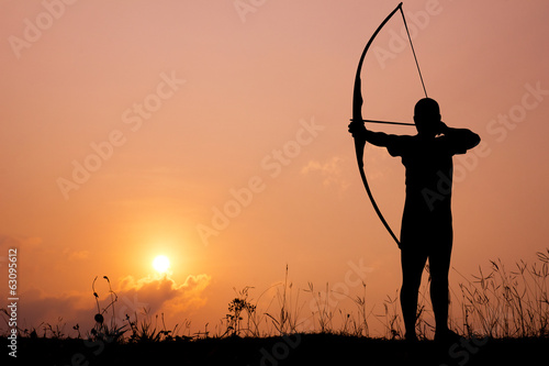 Fotografie, Tablou Silhouette archery shoots a bow