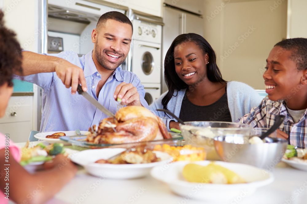 Family Sitting Around Table At Home Eating Meal Family Sitting Around Table At Home Eating Meal