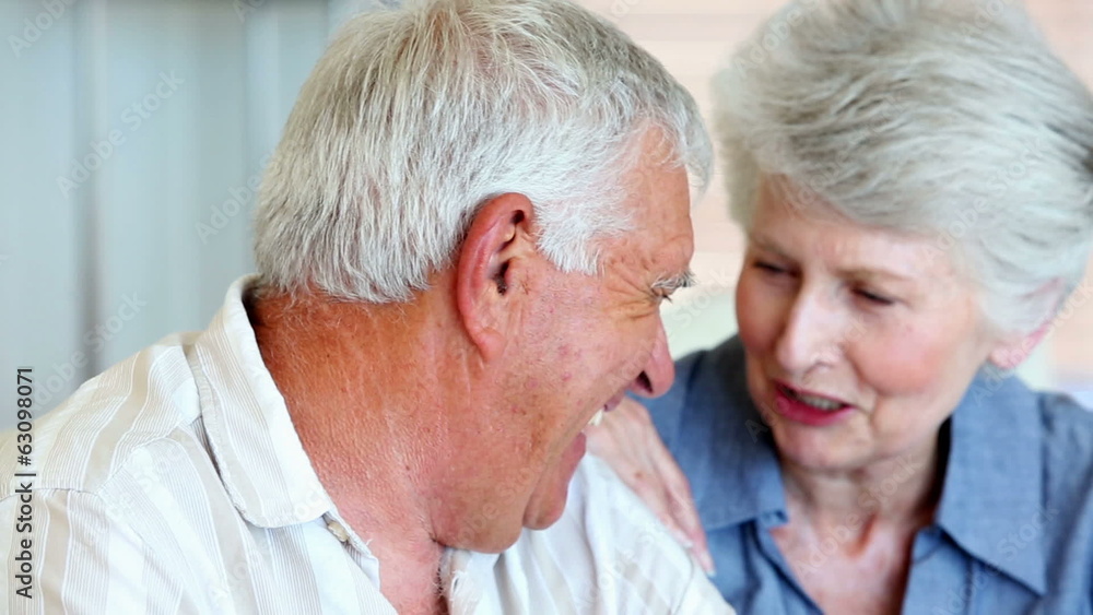 Senior couple smiling at the camera together Senior couple smiling at the camera together