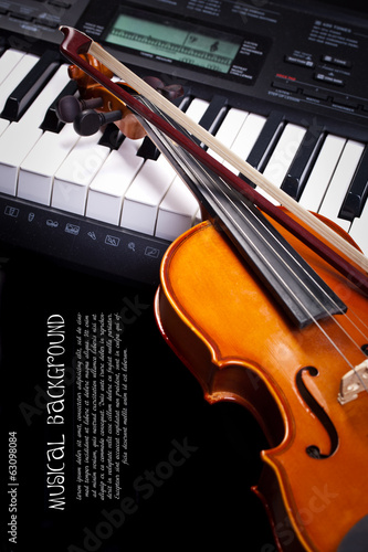 Violin and piano keys on black