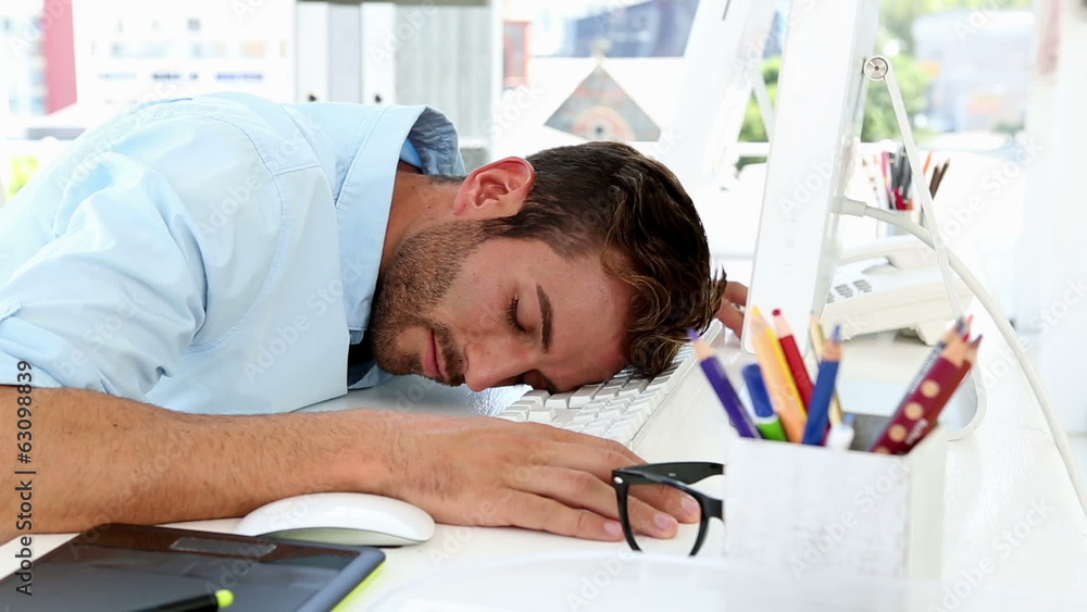 Sleepy designer falling asleep at desk Sleepy designer falling asleep at desk