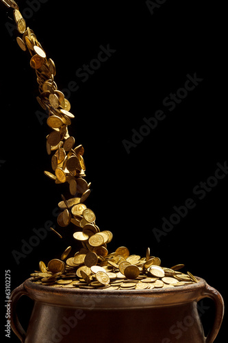 gold coins falling in the vintage pot photo