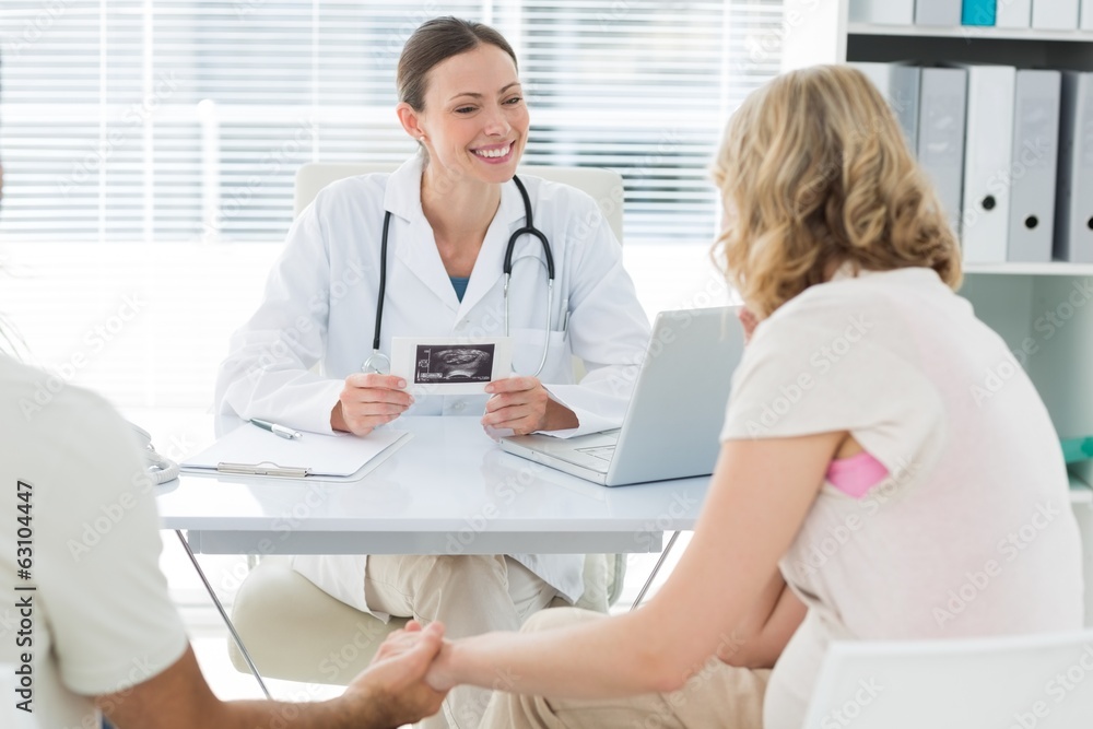 Gynaecologist talking to expectant couple