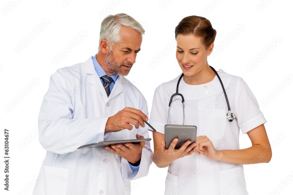 Male and female doctors with digital tablets Male and female doctors with digital tablets
