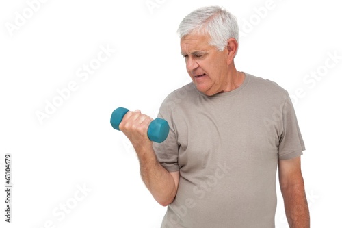 Portrait of a senior man exercising with dumbbell