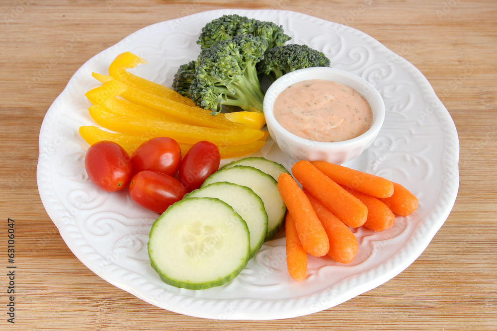 Raw vegetables on white plate with dip Raw vegetables on white plate with dip