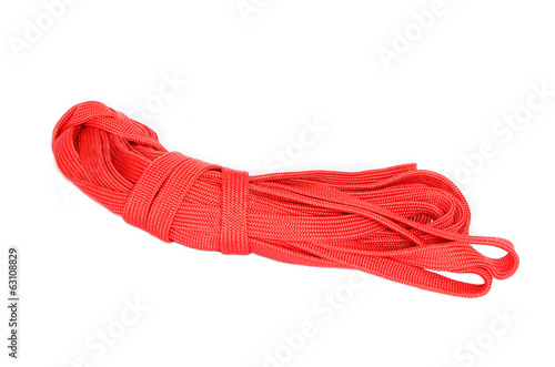 closeup of a coil of red rope on a white background