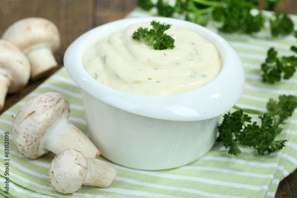 Delicate mushroom sauce in bowl on wooden table close-up Delicate mushroom sauce in bowl on wooden table close-up