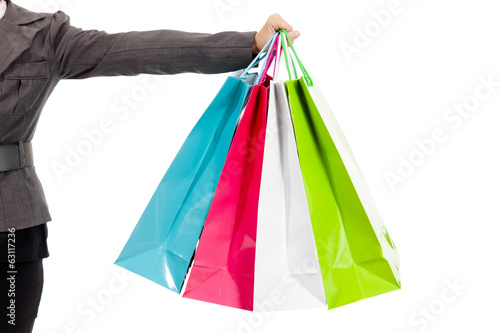 Female s hand holding colorful shopping bags
