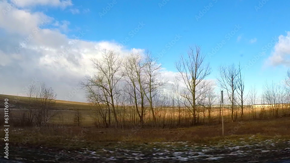 Spring Driving View with Last Snow, Dramatic Blue Skies and Clou