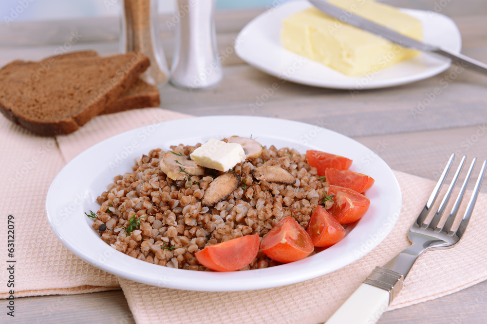Boiled buckwheat on plate on table close-up Boiled buckwheat on plate on table close-up