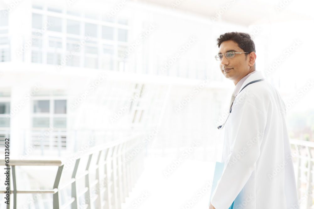 Asian Indian male medical doctor inside hospital.