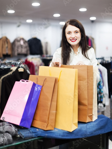 Smiling girl buyer with shopping bags © JackF