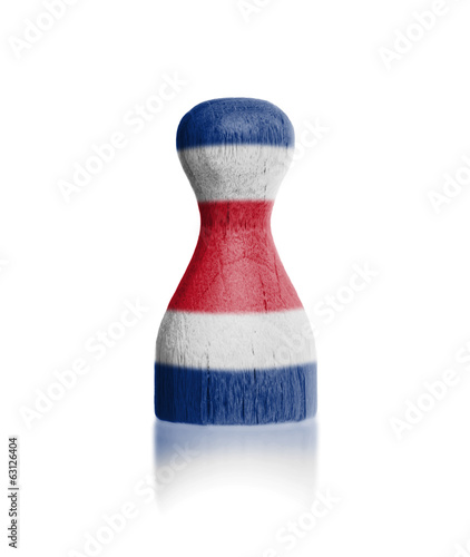 Wooden pawn with a painting of a flag photo