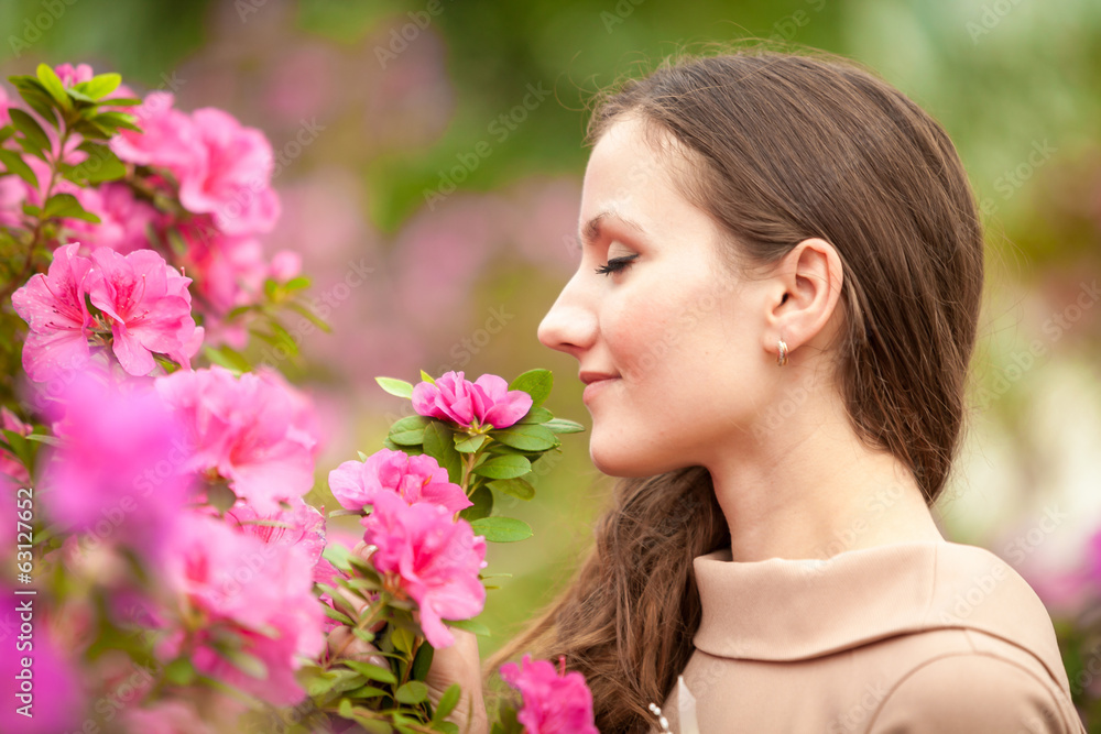 Portrait of beautiful woman smelling pink flowers on tree Portrait of beautiful woman smelling pink flowers on tree