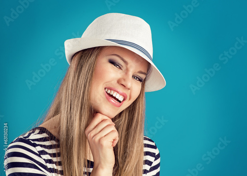 Happy girl wearing striped clothing and white summer hat