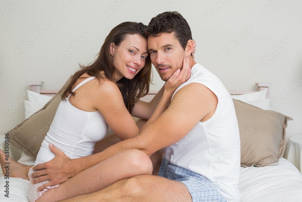 Portrait of a loving couple sitting in bed Portrait of a loving couple sitting in bed