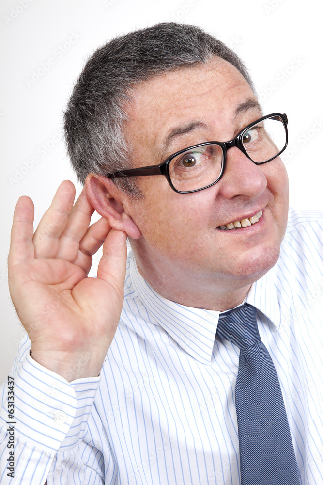 Man holding his ear to hear better Man holding his ear to hear better