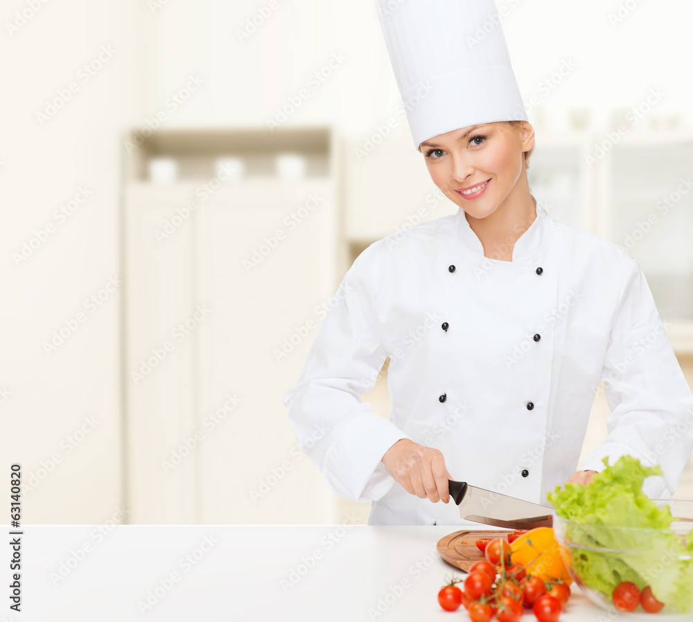 smiling female chef chopping vagetables smiling female chef chopping vagetables