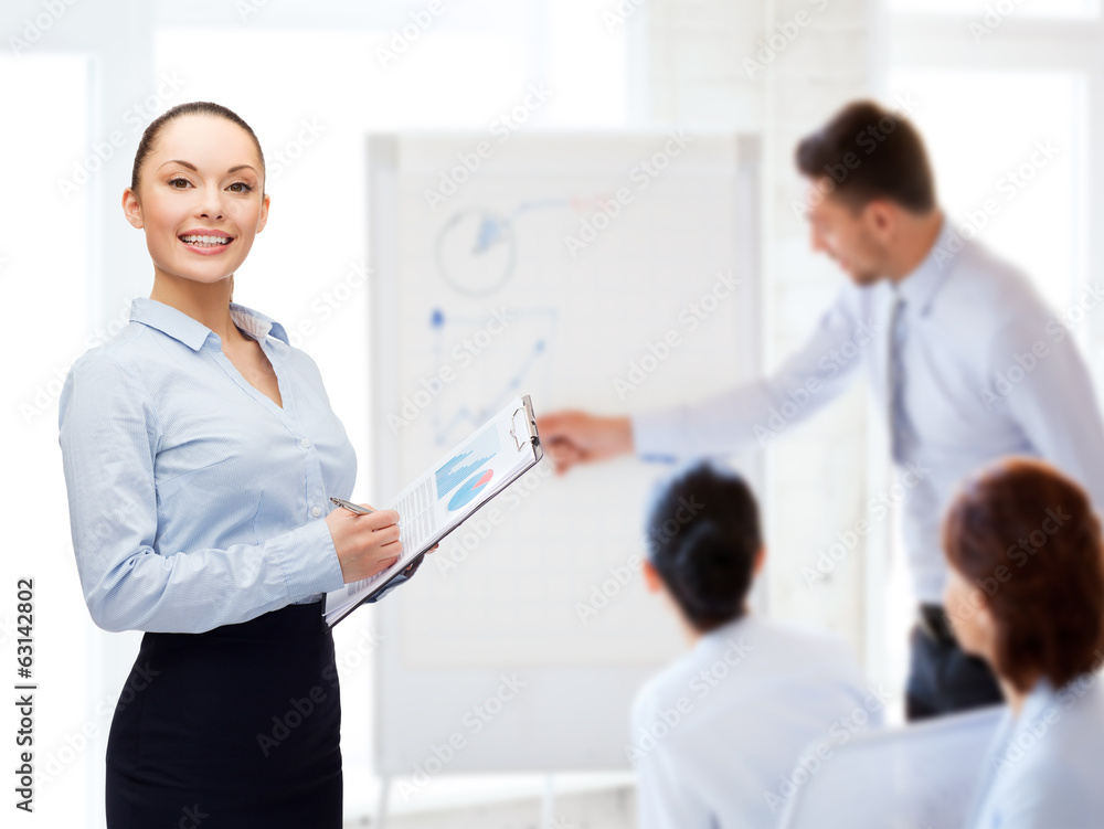 young smiling businesswoman with clipboard and pen young smiling businesswoman with clipboard and pen