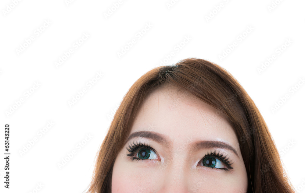 Close up of female eyes looking up isolated on white background Close up of female eyes looking up isolated on white background