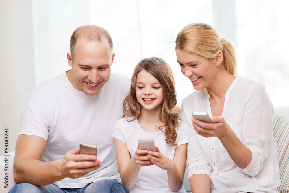 parents and little girl with smartphones at home parents and little girl with smartphones at home