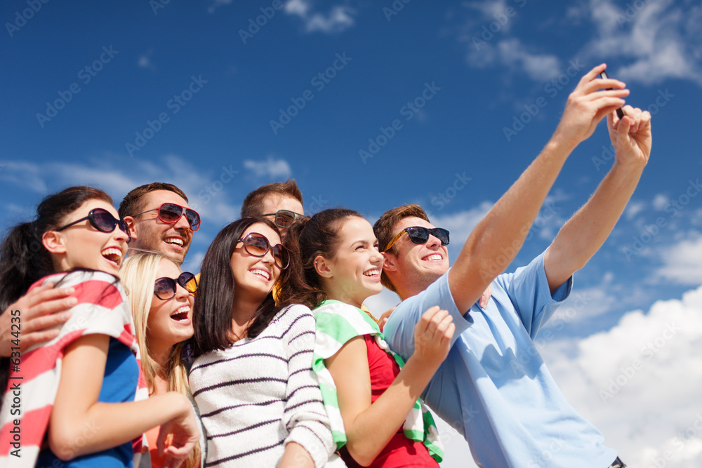 group of friends taking picture with smartphone group of friends taking picture with smartphone