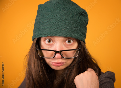 Obraz na płótnie the girl with glasses and hat on a yellow background