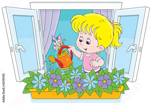Little girl watering flowers on a windowsill