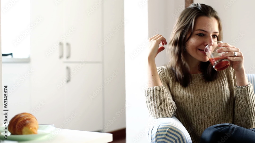 Young happy woman drinking juice at home Young happy woman drinking juice at home