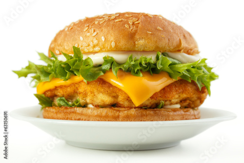 Fish burger with cheese and mayonnaise on dish