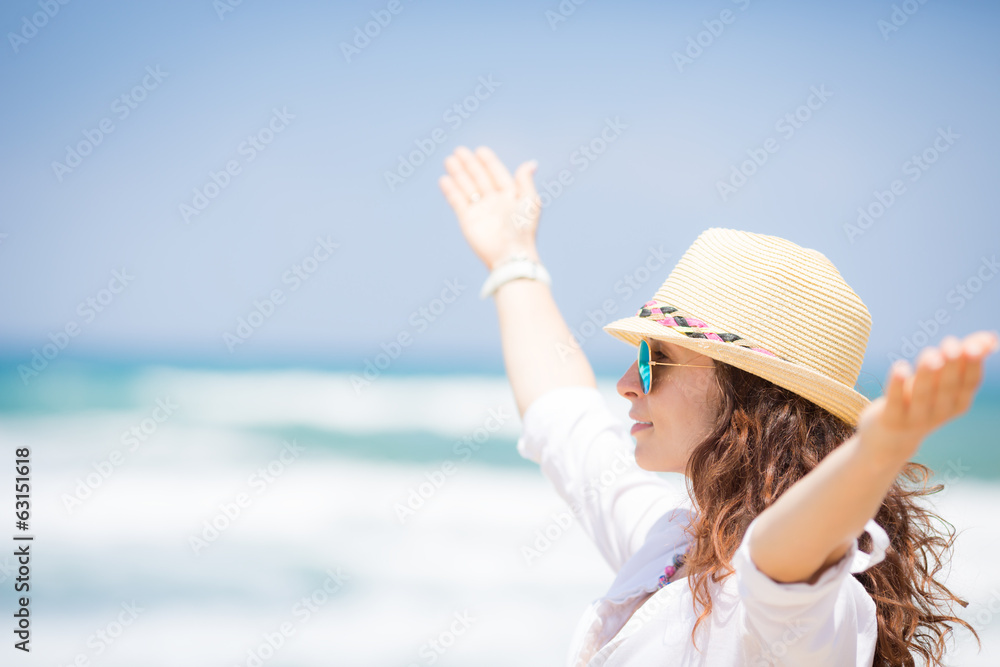 Happy woman enjoying at the beach