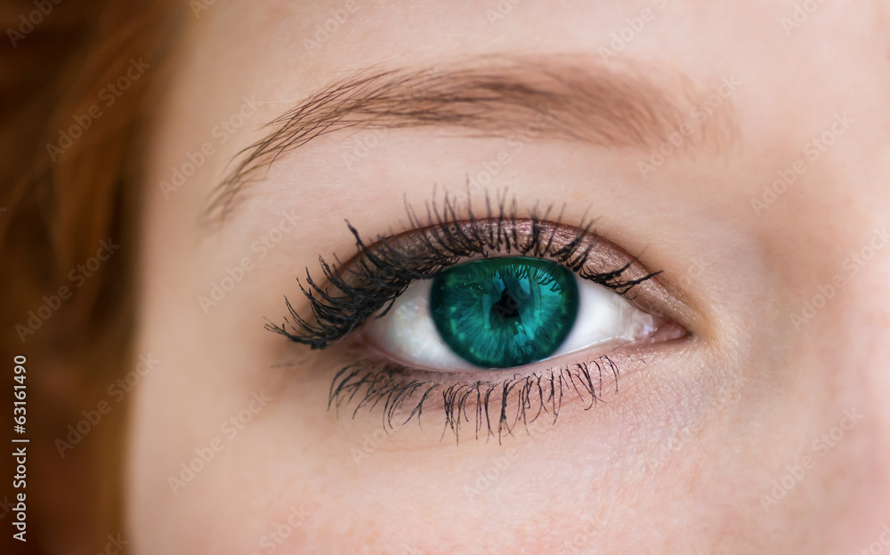 Human with emerald colored eye with reflection. Macro shot. Human with emerald colored eye with reflection. Macro shot.