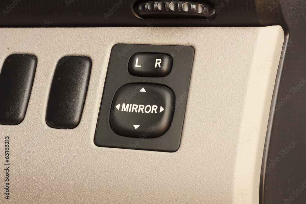 Side mirrors control switch in the car. Side mirrors control switch in the car.