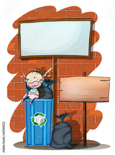 Two empty signboards near the trashcan with a baby