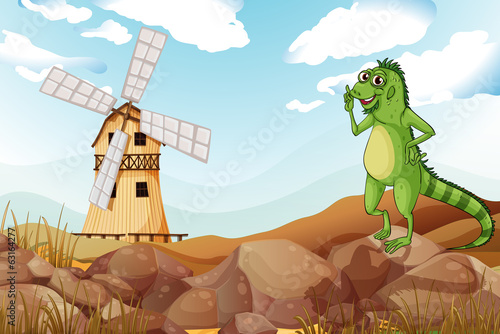 A smiling lizard across the wooden barnhouse with a windmill