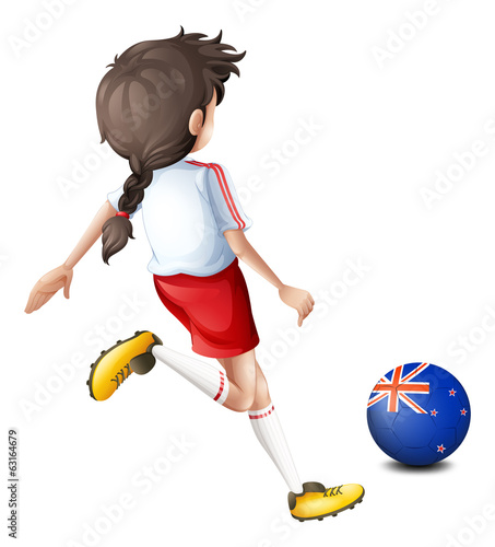 A lady kicking the ball with the flag of New Zealand