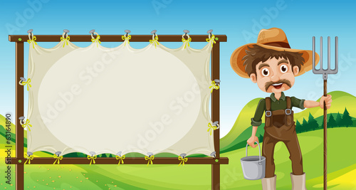A farmer beside the empty signage