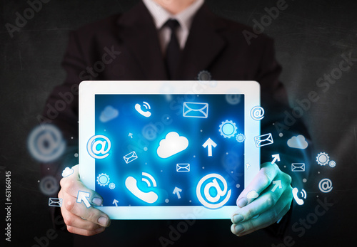 Person holding a tablet with blue technology icons and symbols