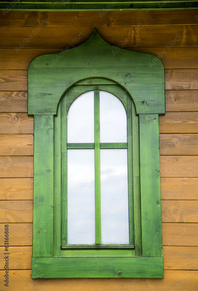 Fototapeta premium Green window on the wooden house