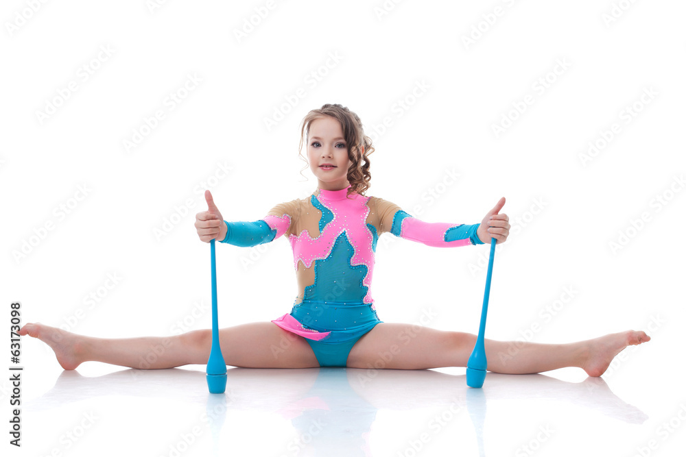Cute gymnast posing sitting on splits with mace Cute gymnast posing sitting on splits with mace