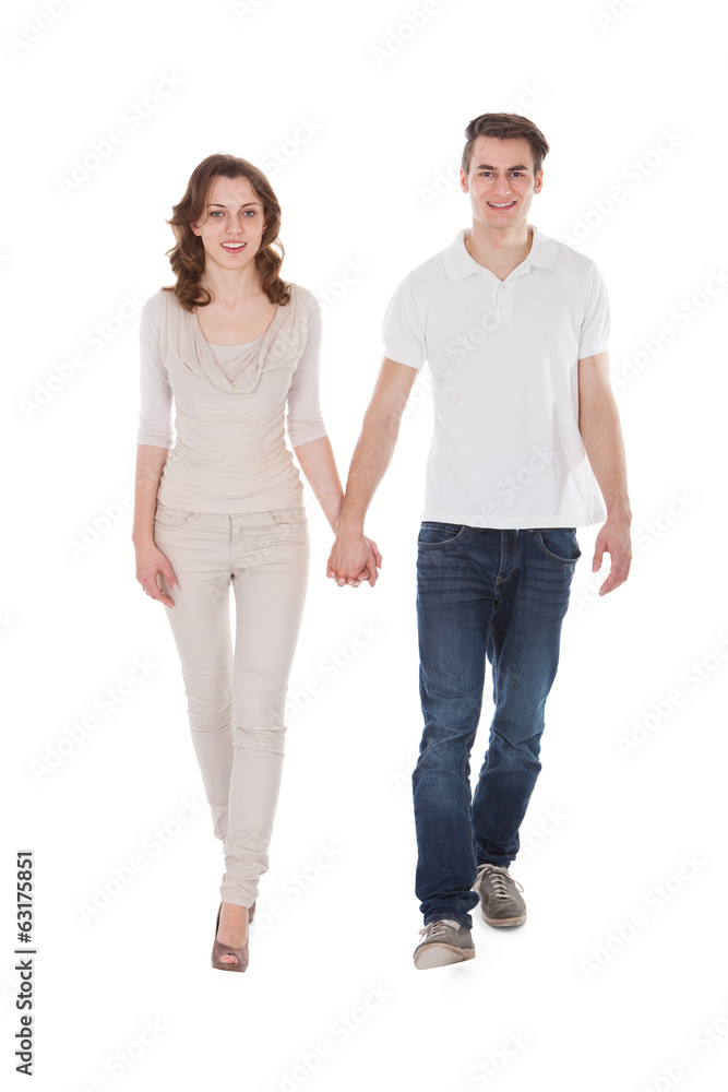 Couple In Casuals Walking Over White Background Couple In Casuals Walking Over White Background
