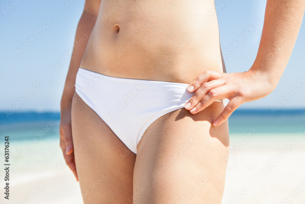 Woman In Bikini Standing On Beach - obrazy, fototapety, plakaty 