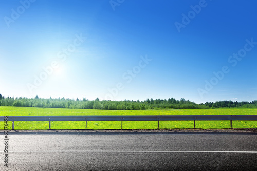 road and field of spring grass
