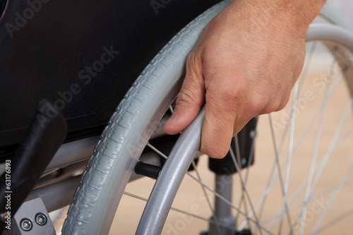 Photos Handicapped Man's Hand Pushing Wheel Of Wheelchair