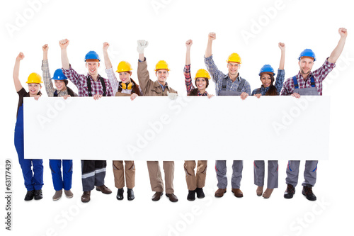 Εκτύπωση καμβά Group of workmen holding a blank white banner