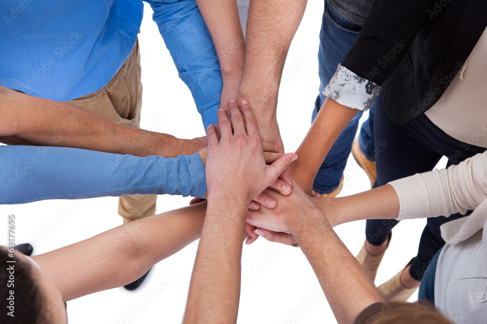 Group of people stacking hands together Group of people stacking hands together